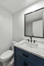 Full bathroom with vanity, a textured ceiling, and a shower