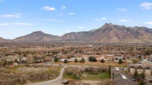 View of mountain backdrop featuring nearby suburban area