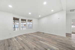 Spare room featuring light wood-type flooring and recessed lighting