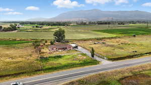 Overview of rural landscape with a mountain backdrop and extensive farmland