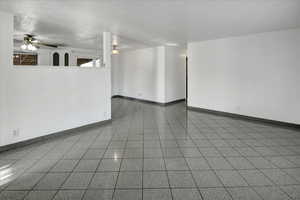 Spare room featuring baseboards and ceiling fan