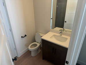 Bathroom with vanity, light wood finished floors, and a shower