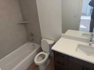Full bath with wood finished floors, shower / bathtub combination, and vanity