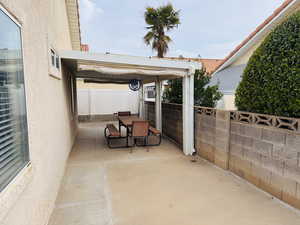 Fenced backyard with outdoor dining space and a patio