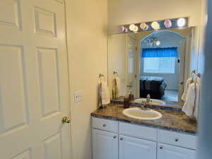 Bathroom with vanity, ceiling fan, and ensuite bathroom
