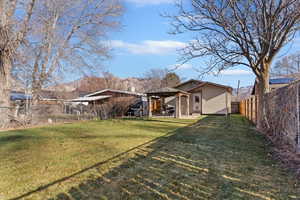 Fenced backyard featuring a patio area and a gazebo