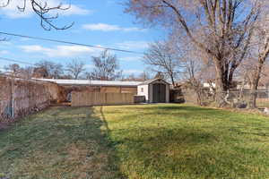 Fenced backyard with a storage unit