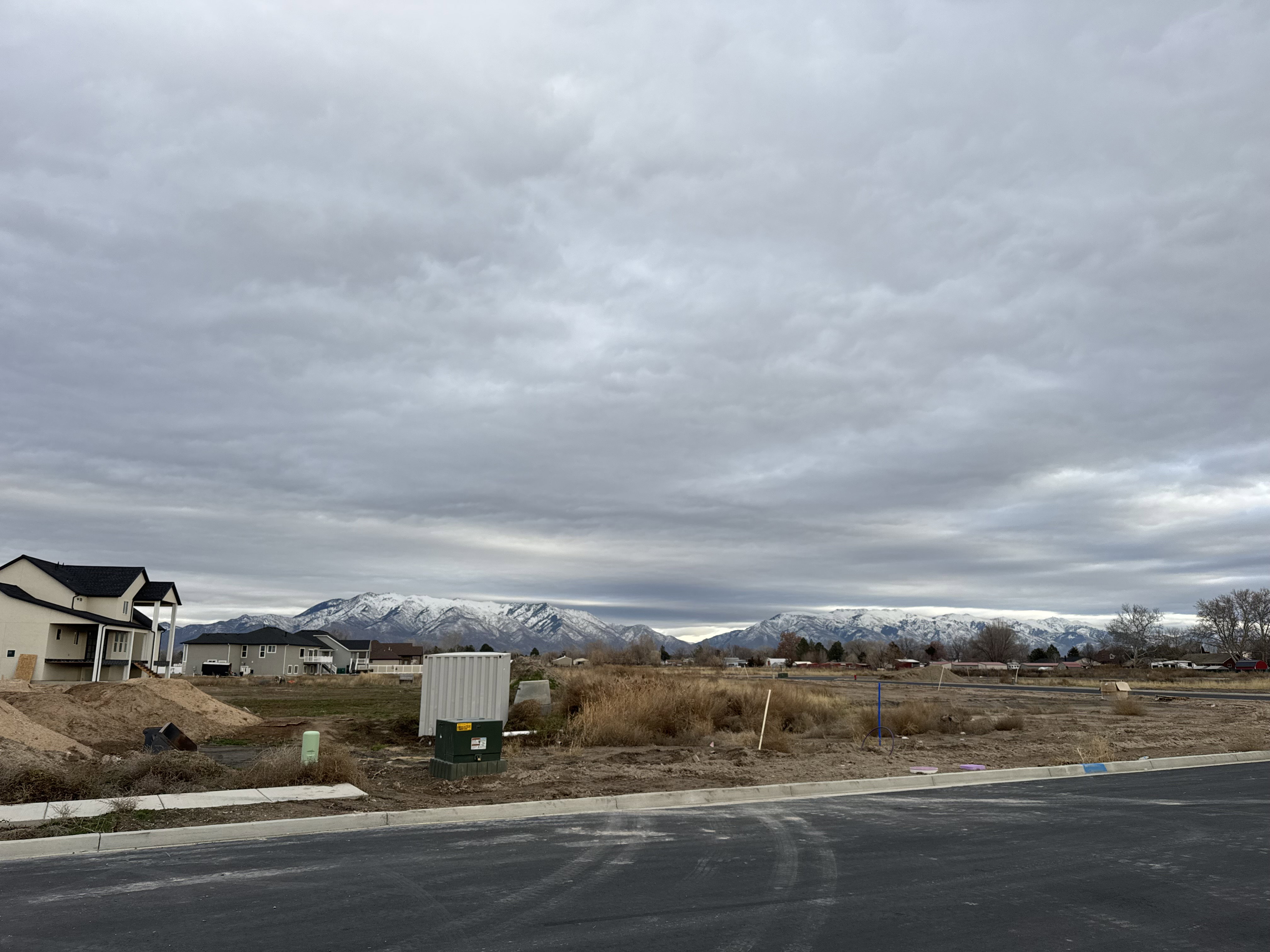 View of asphalt street with curbs and a mountain view