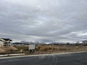 View of asphalt street with curbs and a mountain view