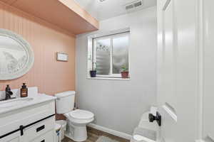 Half bath featuring vanity and wood finished floors