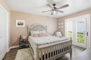 Bedroom with dark wood-style floors, a ceiling fan, a closet, and access to exterior