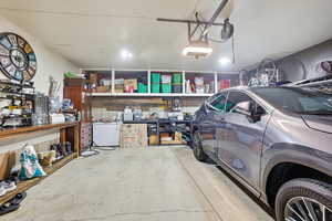 Garage featuring white refrigerator