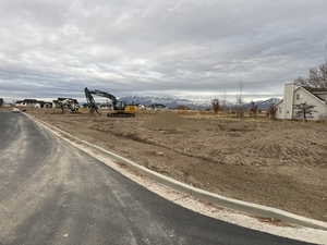 View of asphalt road featuring curbs