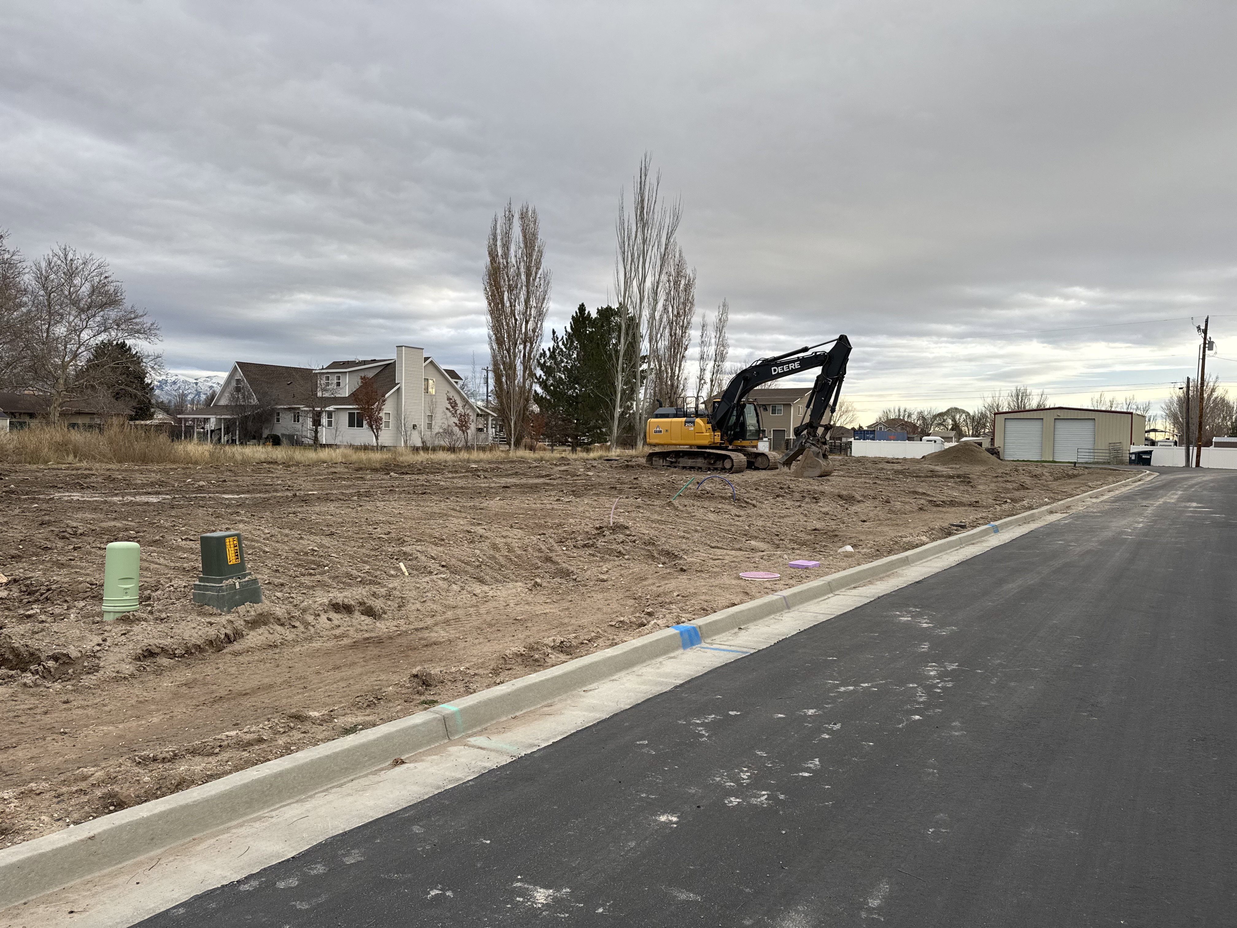 View of asphalt street featuring curbs