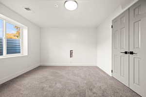 Unfurnished bedroom with carpet and a closet