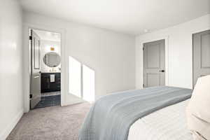 Bedroom featuring carpet and ensuite bathroom