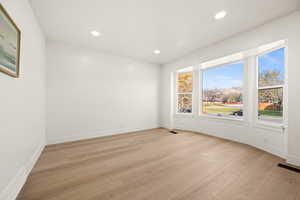 Unfurnished room with light wood finished floors and recessed lighting