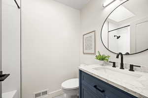 Bathroom featuring vanity and a shower