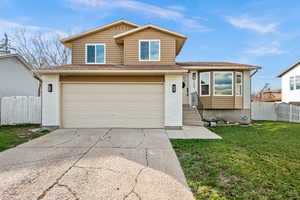 View of front of home featuring brick siding, an attached garage, and concrete driveway