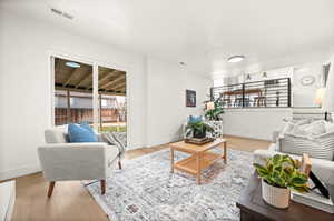 Living room with light wood-style floors and baseboards