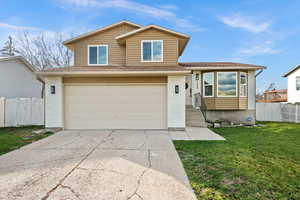 View of front of home featuring brick siding, an attached garage, and driveway