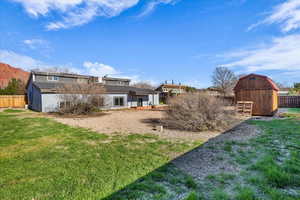 View of yard with a storage shed and a barn