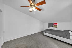 Bedroom with lofted ceiling, carpet flooring, and ceiling fan