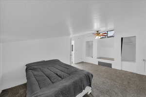 Carpeted bedroom featuring ceiling fan and multiple closets