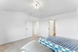 Bedroom featuring vaulted ceiling and carpet floors
