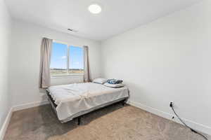 Carpeted bedroom with baseboards