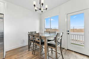 Dining area featuring a chandelier and light wood-type flooring