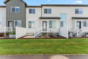 Rear view of property with board and batten siding and stucco siding
