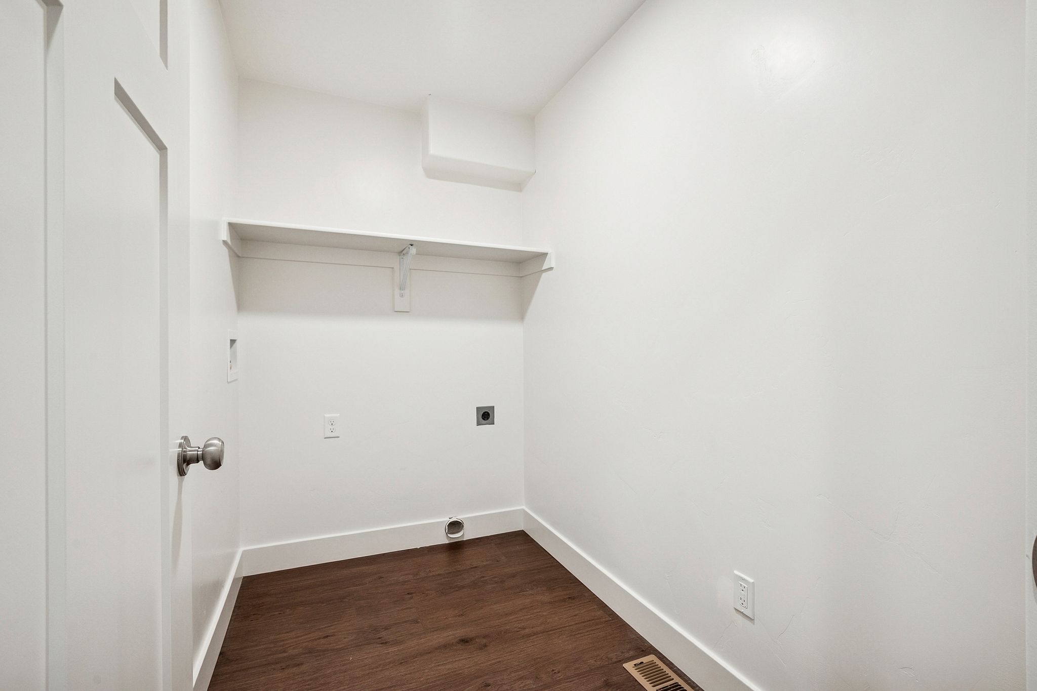 Laundry area featuring dark wood-style floors and hookup for an electric dryer