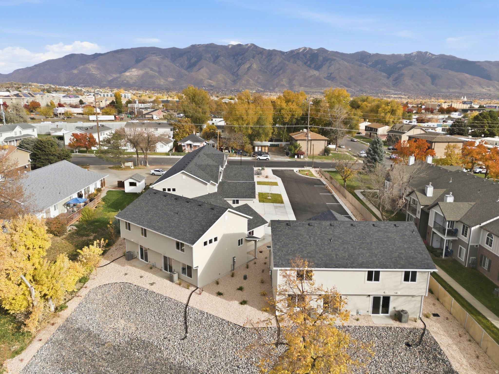 Aerial view of residential area featuring a mountainous background