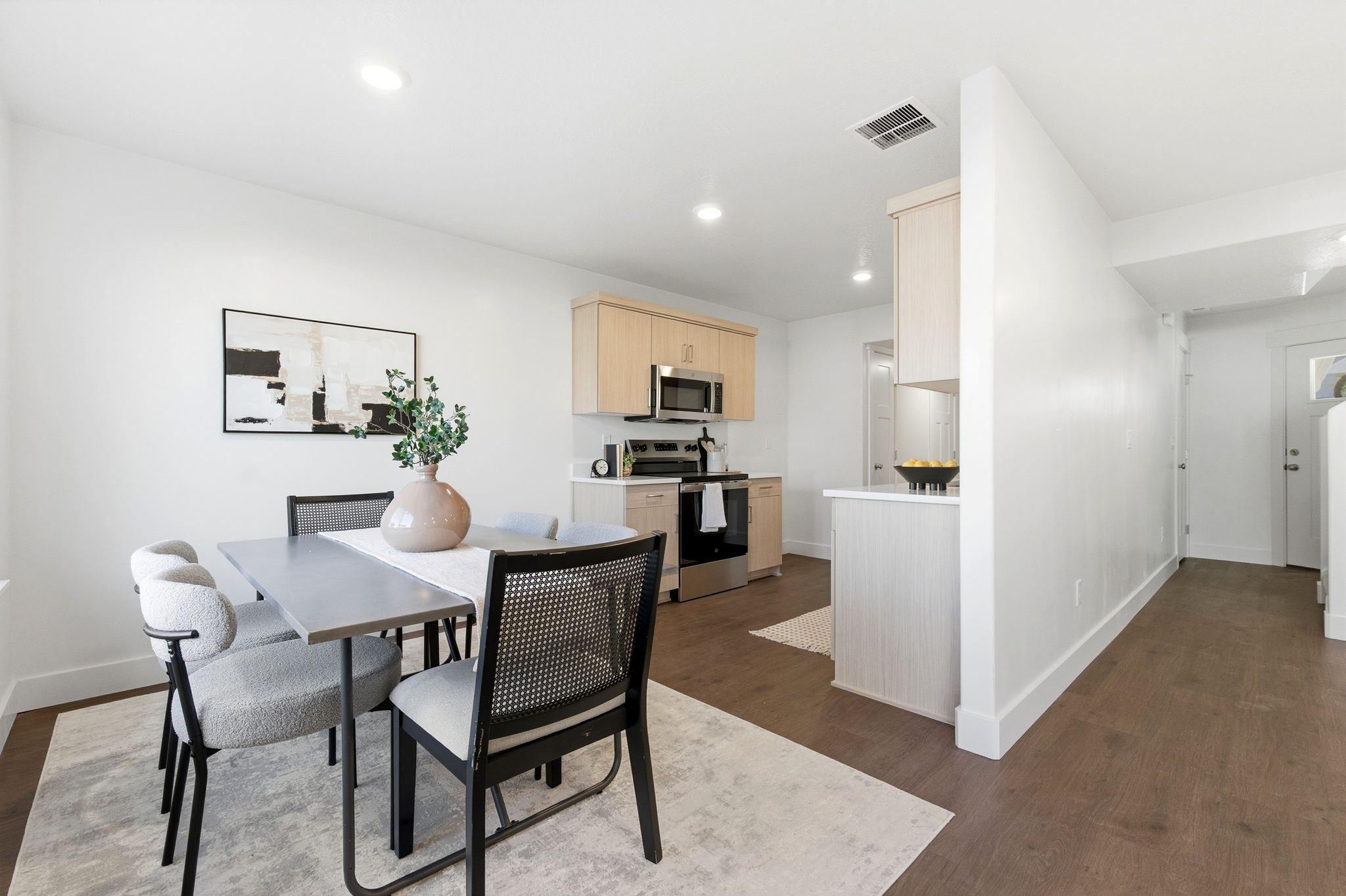 Dining space featuring dark wood-type flooring and recessed lighting