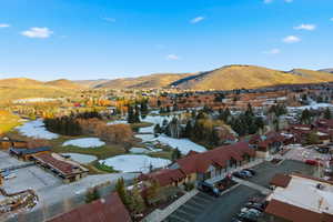 Snowy aerial view featuring a mountain view