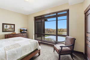 Bedroom featuring light carpet