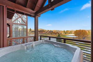 View of pool featuring a hot tub and a residential view