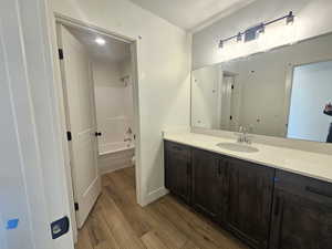 Full bathroom featuring vanity, shower / bathtub combination, and light wood-type flooring
