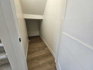 Staircase featuring a textured ceiling and wood finished floors