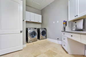 Washroom with washing machine and dryer and cabinet space