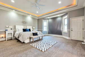 Bedroom with crown molding, carpet floors, a raised ceiling, recessed lighting, and a ceiling fan