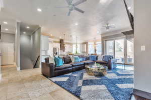 Living area with recessed lighting, crown molding, and ceiling fan