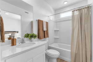 Bathroom with shower / bath combo with shower curtain and vanity