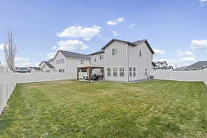 Back of house with a gazebo, a patio, and a fenced backyard