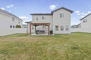 Back of property with a fenced backyard, a patio area, and a gazebo