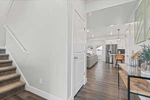 Stairs featuring wood finished floors and baseboards