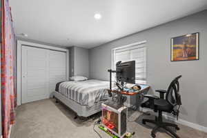 Bedroom featuring a closet, light colored carpet, an office area, and recessed lighting