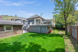 Back of property with a deck and storage underneath