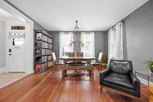 Dining space with wood-type flooring and baseboards